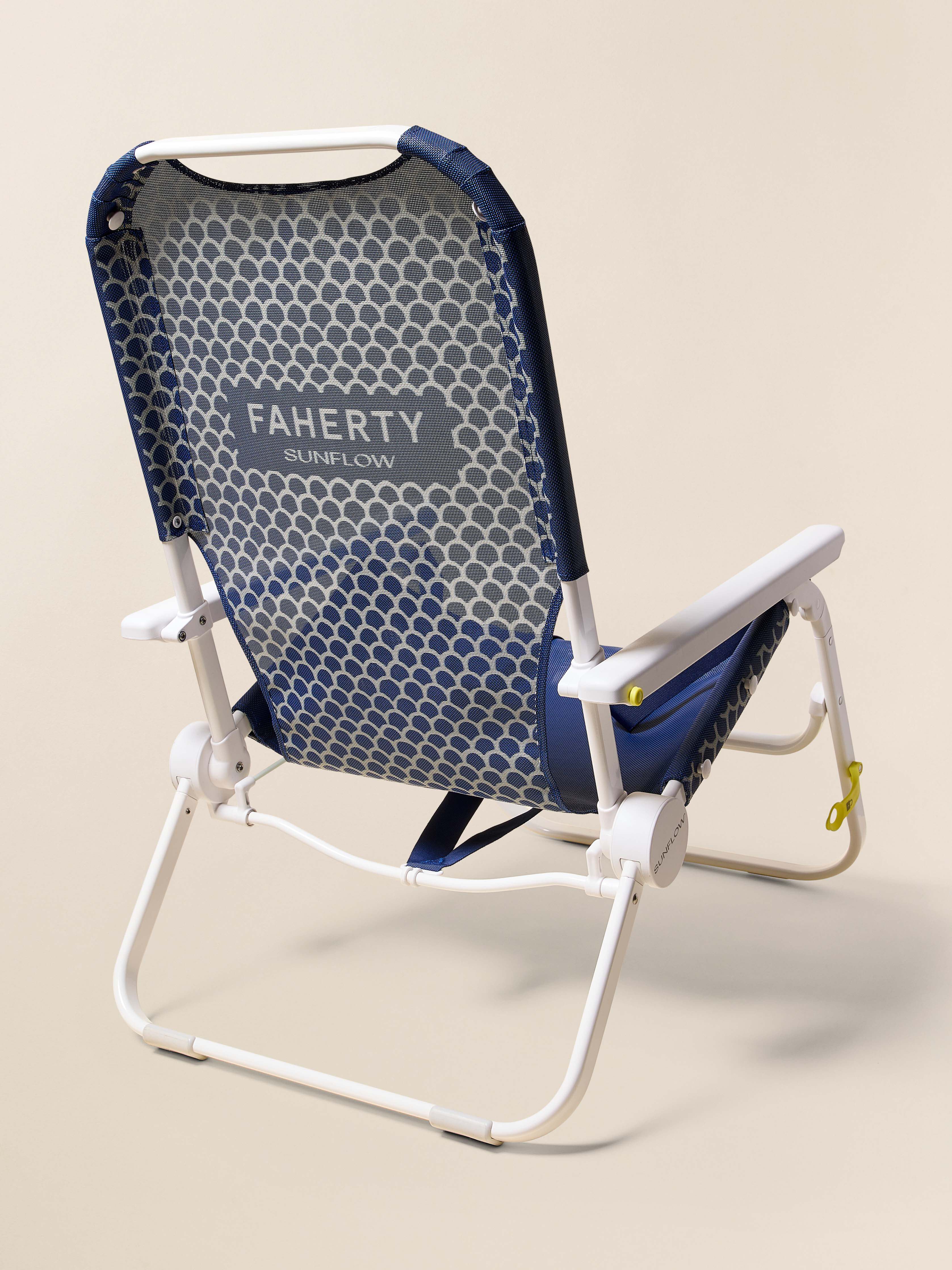 Foldable beach chair with blue and gray pattern on a beige background