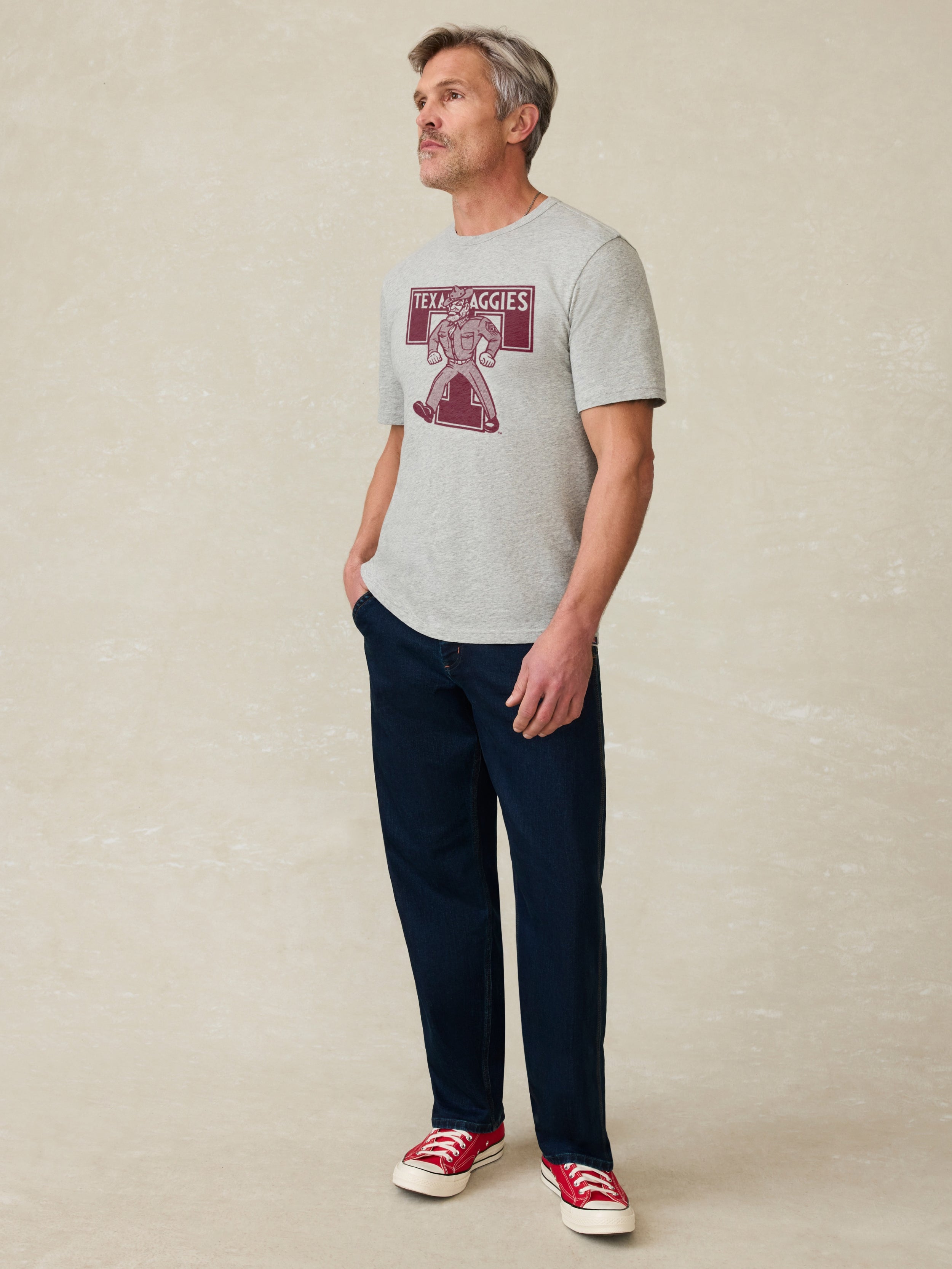 Grey t-shirt with Texas A&M graphic on front against a beige background