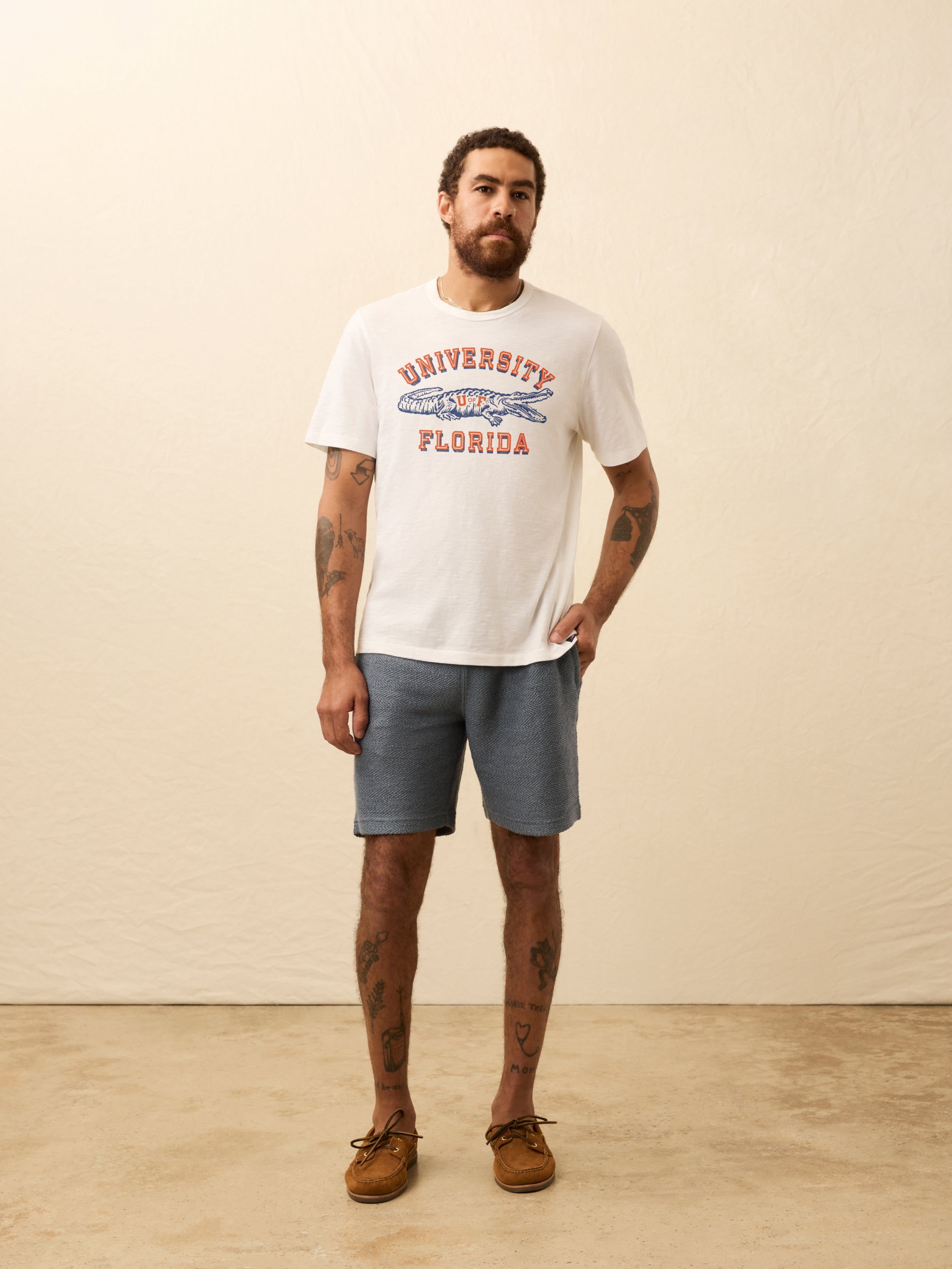 White t-shirt with University of Florida graphic on the front against beige background