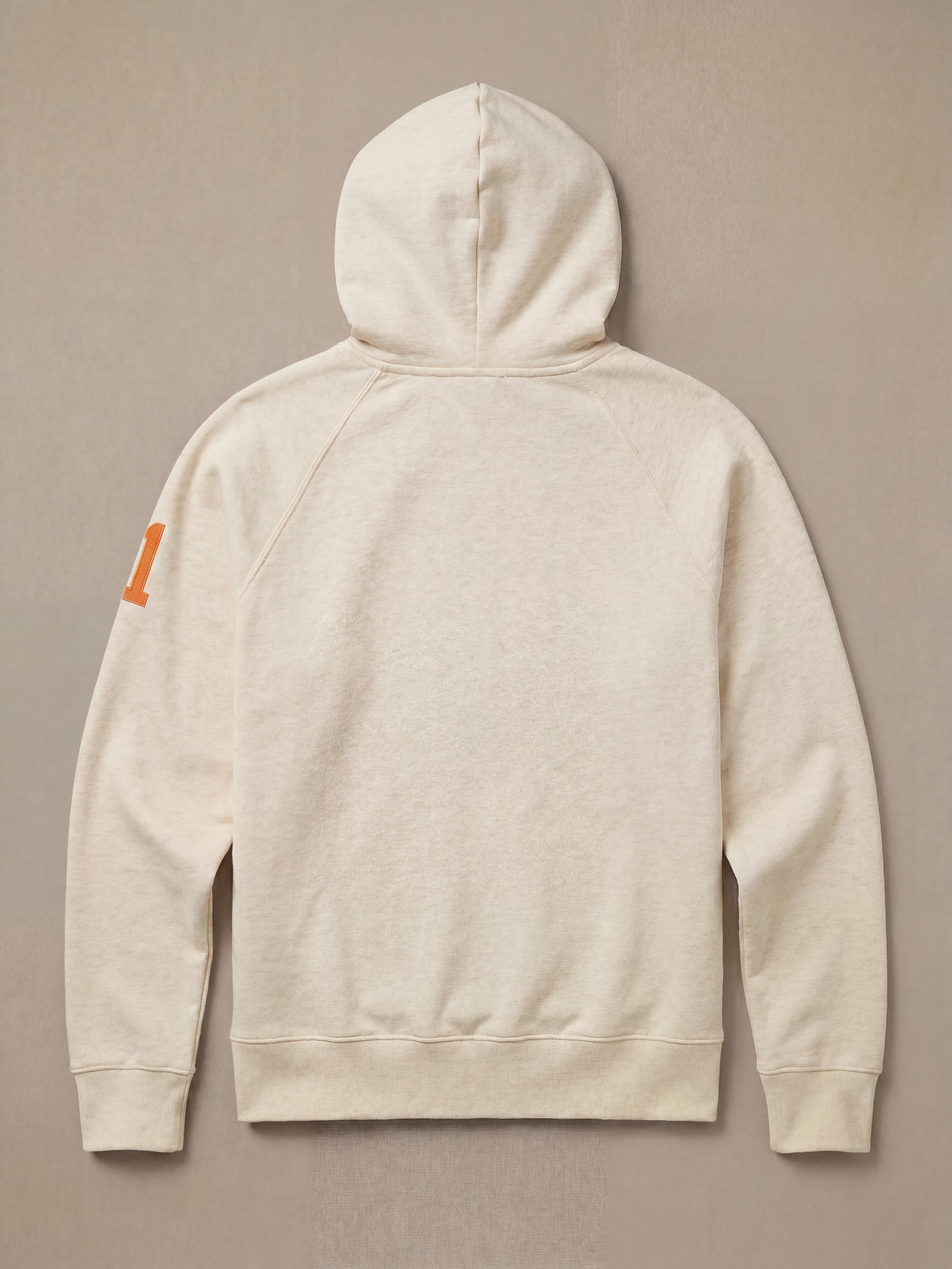 White hoodie against a beige background