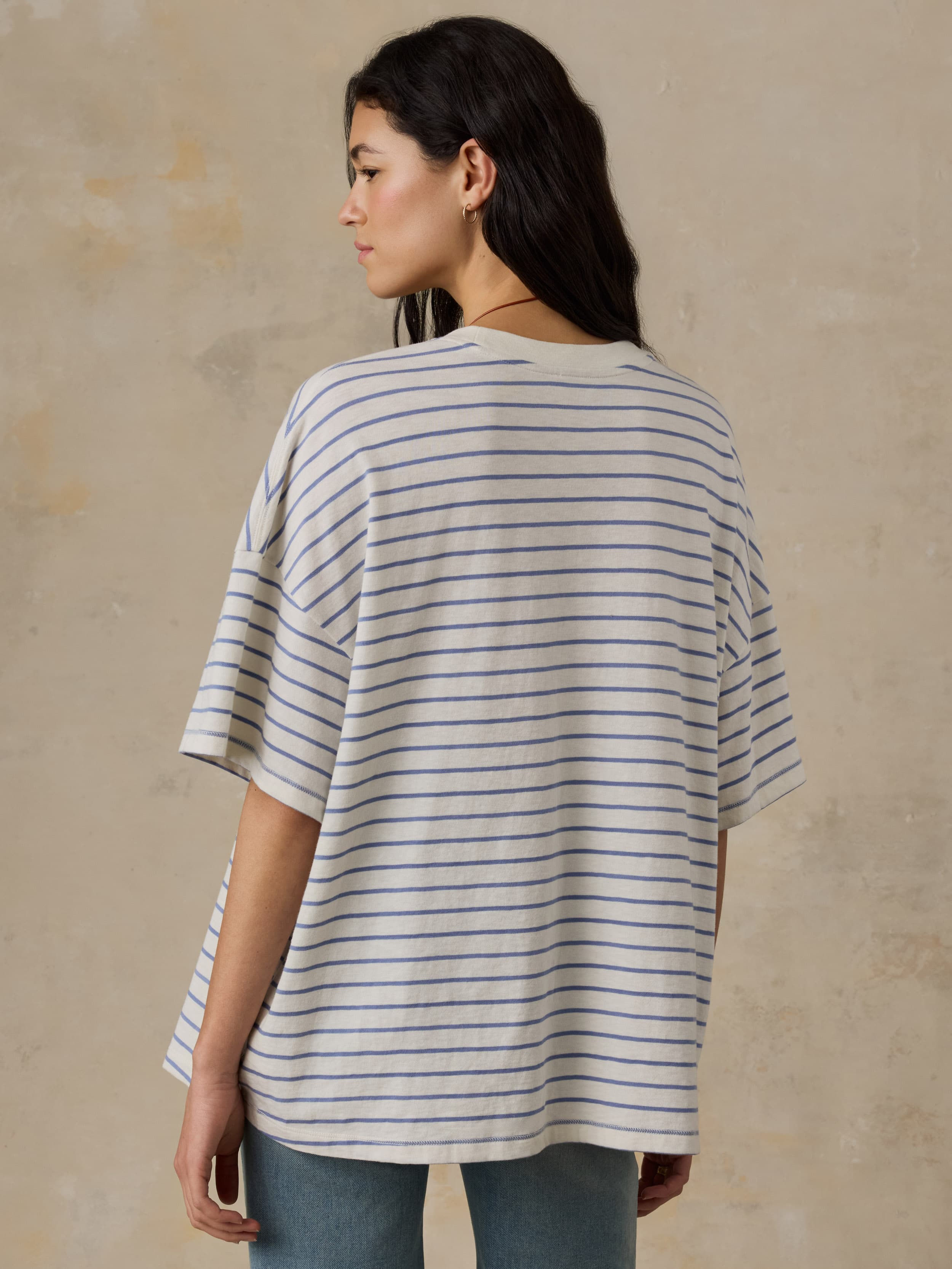 Woman wearing a striped t-shirt against a beige background